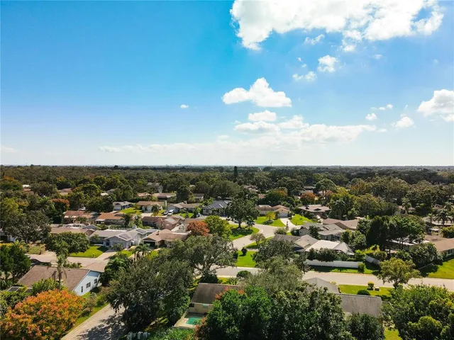 an aerial view of a house with a yard