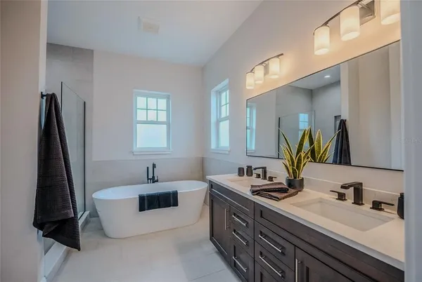 a bathroom with a double vanity sink and a mirror