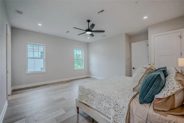 a bedroom with a bed and a chandelier