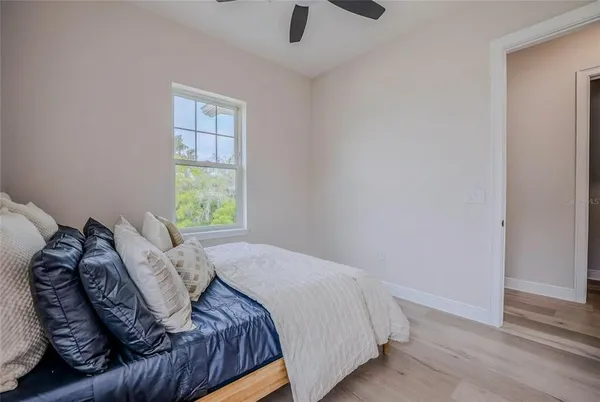 a bed sitting in a bedroom next to a window