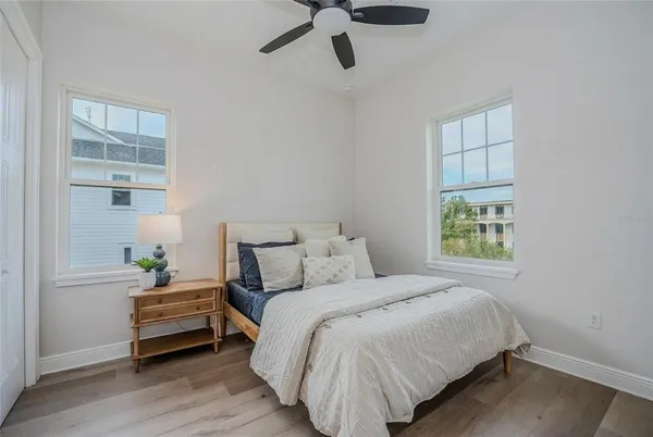 a bedroom with a bed and wooden floor