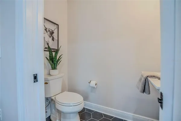 a white toilet sitting next to a white walls