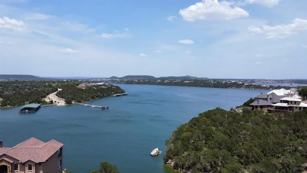 an aerial view of a houses with ocean view