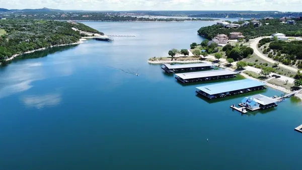 an aerial view of a house with pool lake view and mountain view