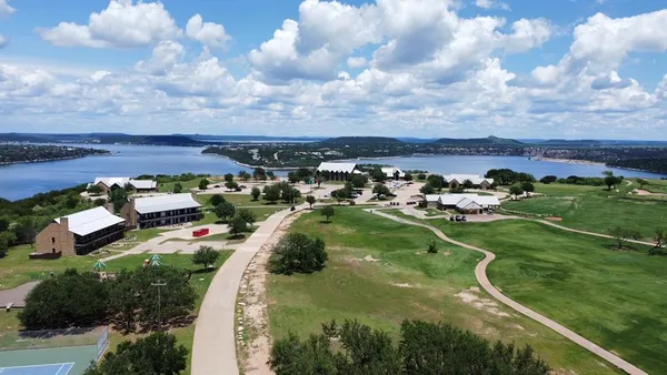a view of a golf course with parking space