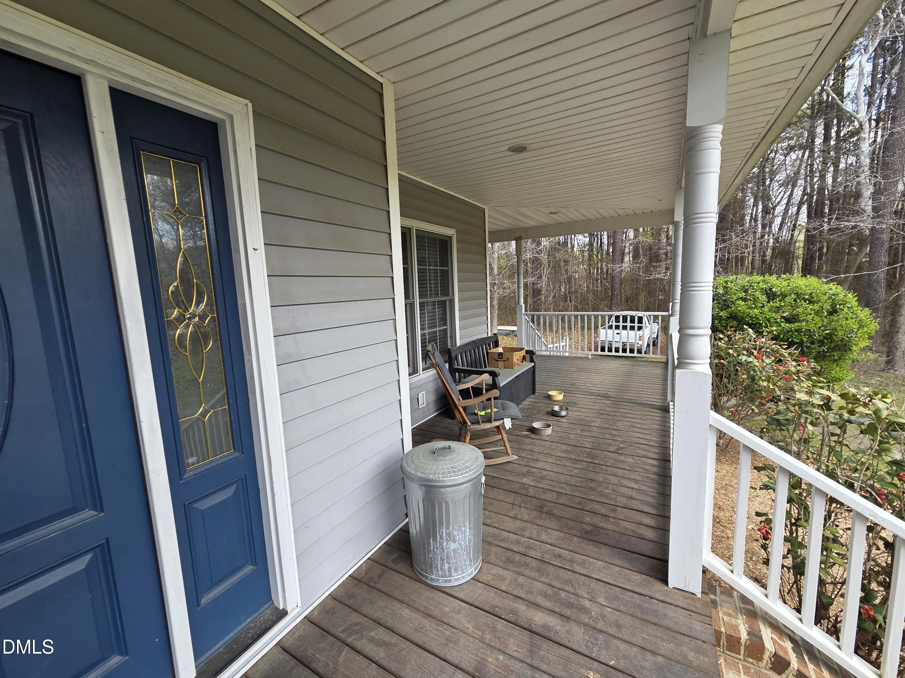 3001 Hidden Spring Lane Oxford, NC 27565 - Photo 14 of 57 a view of a deck with wooden chairs and wooden fence