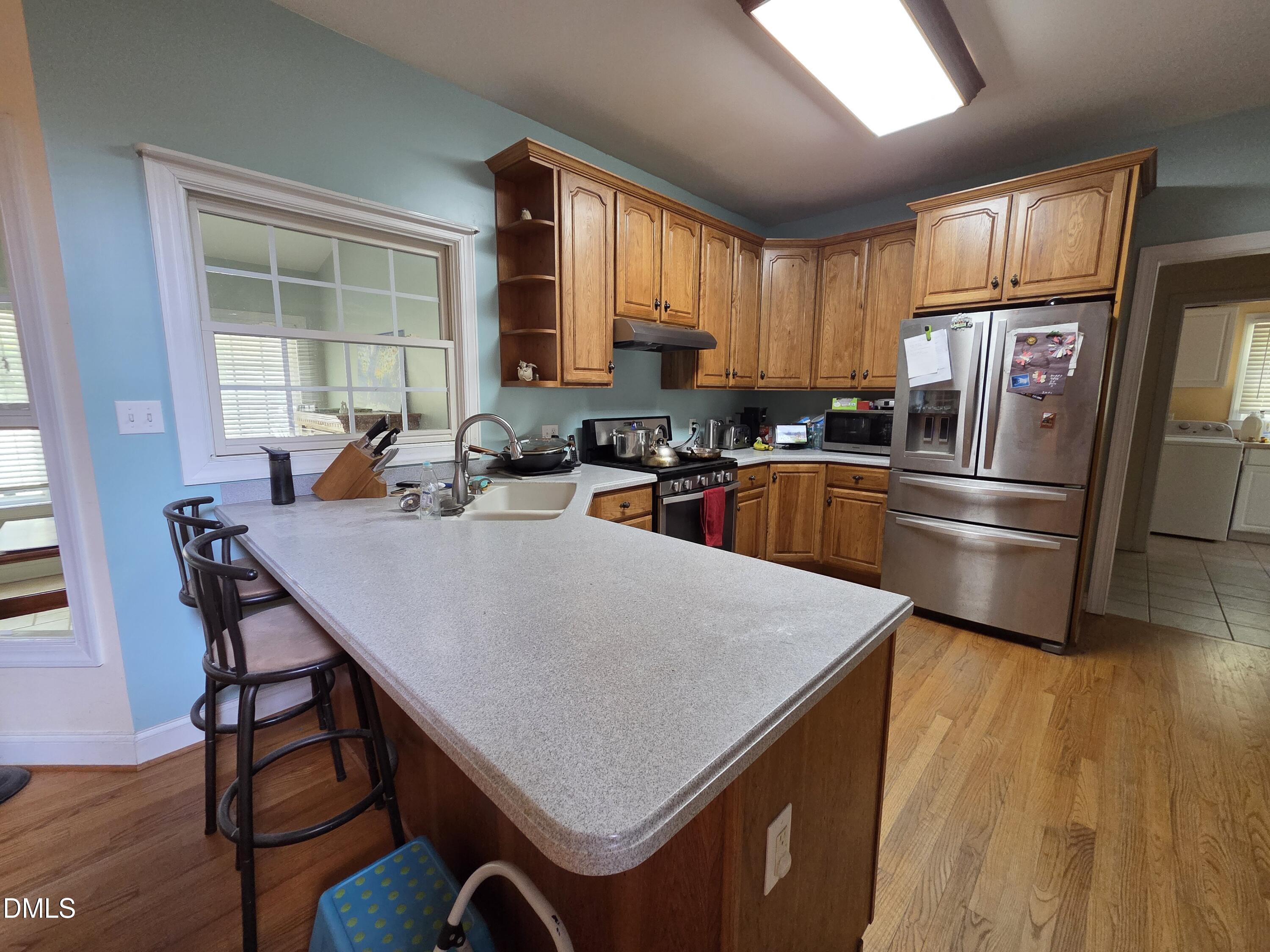 3001 Hidden Spring Lane Oxford, NC 27565 - Photo 19 of 57 a kitchen with a refrigerator a stove a sink dishwasher with a dining table and chair