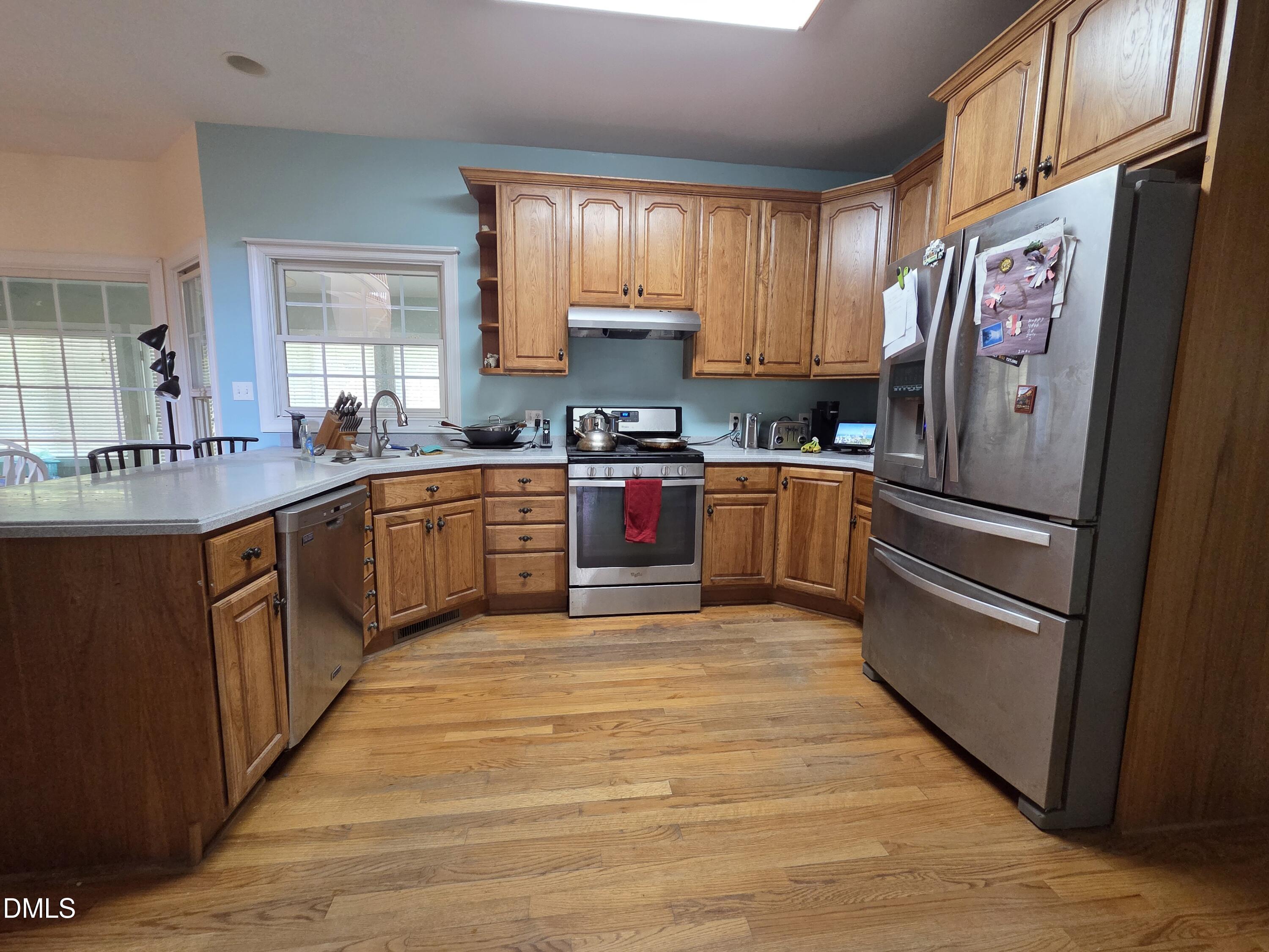 3001 Hidden Spring Lane Oxford, NC 27565 - Photo 20 of 57 a kitchen with stainless steel appliances granite countertop a refrigerator and a stove top oven