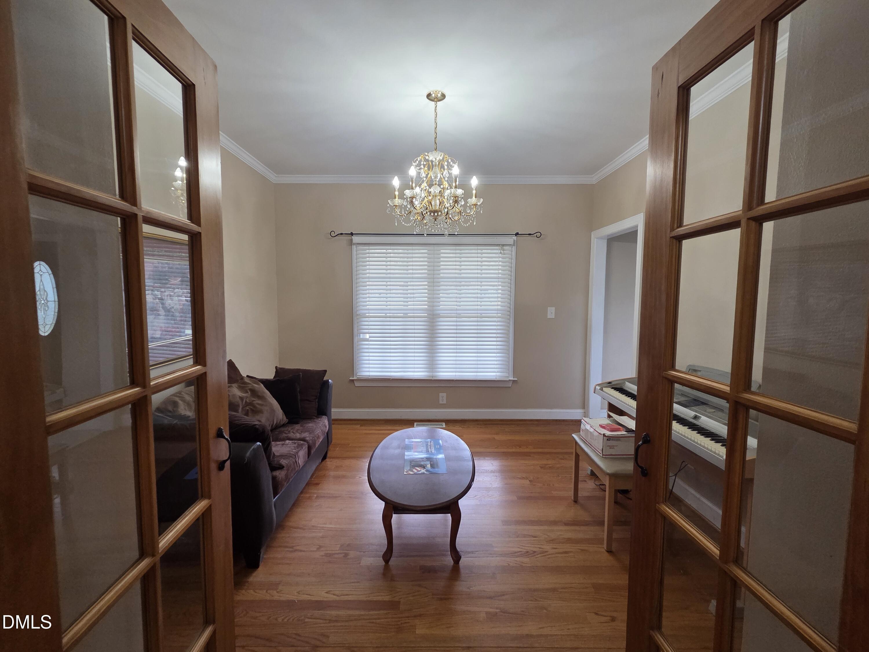3001 Hidden Spring Lane Oxford, NC 27565 - Photo 25 of 57 a view of a livingroom with furniture hardwood floor and a chandelier