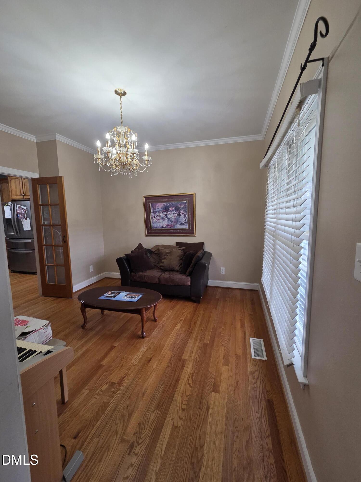 3001 Hidden Spring Lane Oxford, NC 27565 - Photo 26 of 57 a living room with furniture and a chandelier