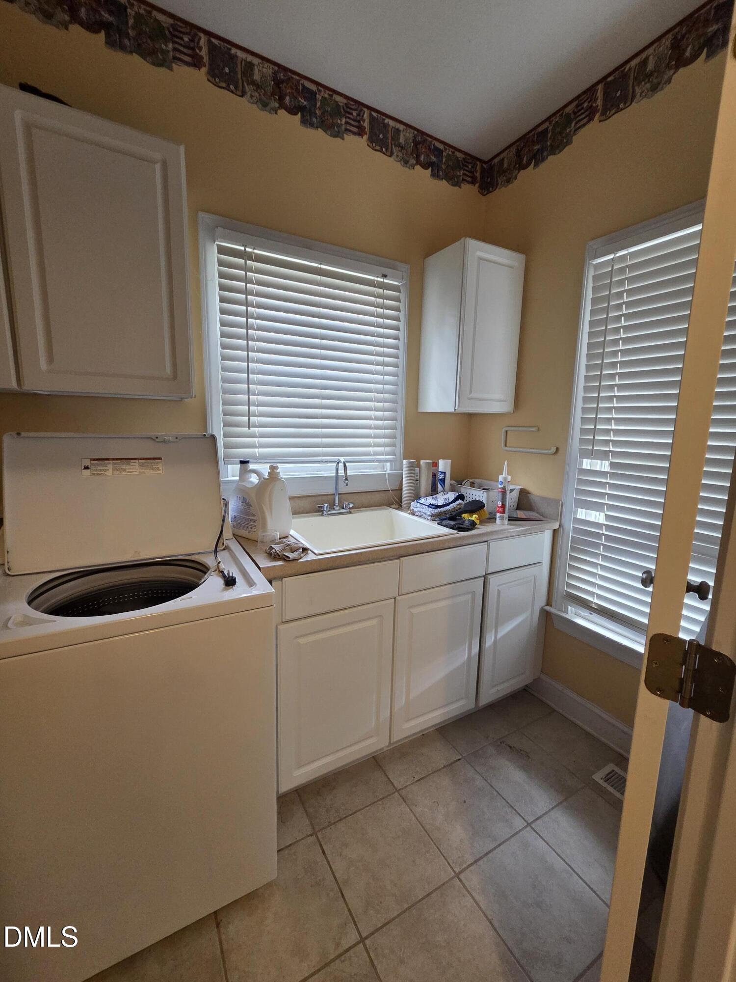 3001 Hidden Spring Lane Oxford, NC 27565 - Photo 30 of 57 a kitchen with a sink a stove and cabinets