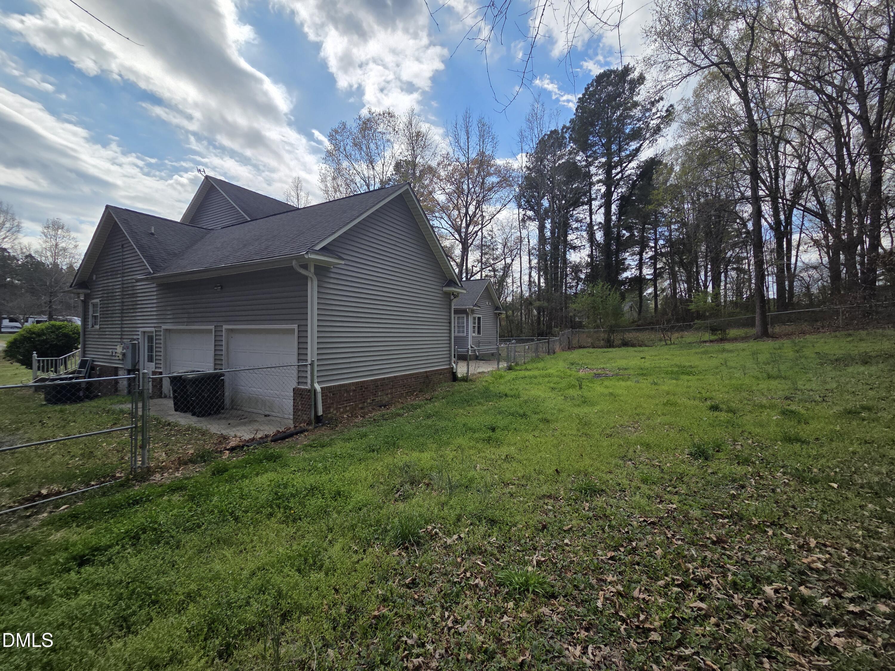 3001 Hidden Spring Lane Oxford, NC 27565 - Photo 6 of 57 a view of a backyard with plants and large tree