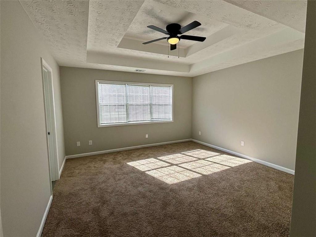 275 Thorn Brook Circle Bethlehem, GA 30620 - Photo 12 of 32 an empty room with a window and a ceiling fan