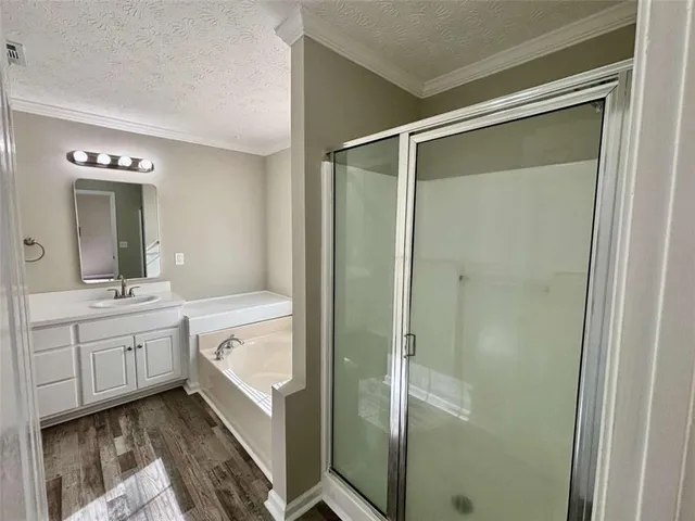 a bathroom with a tub sink and mirror