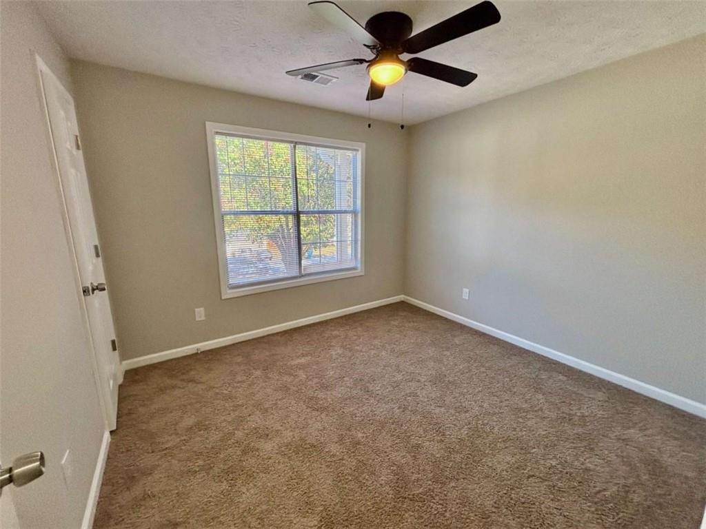275 Thorn Brook Circle Bethlehem, GA 30620 - Photo 20 of 32 an empty room with a window and a fan