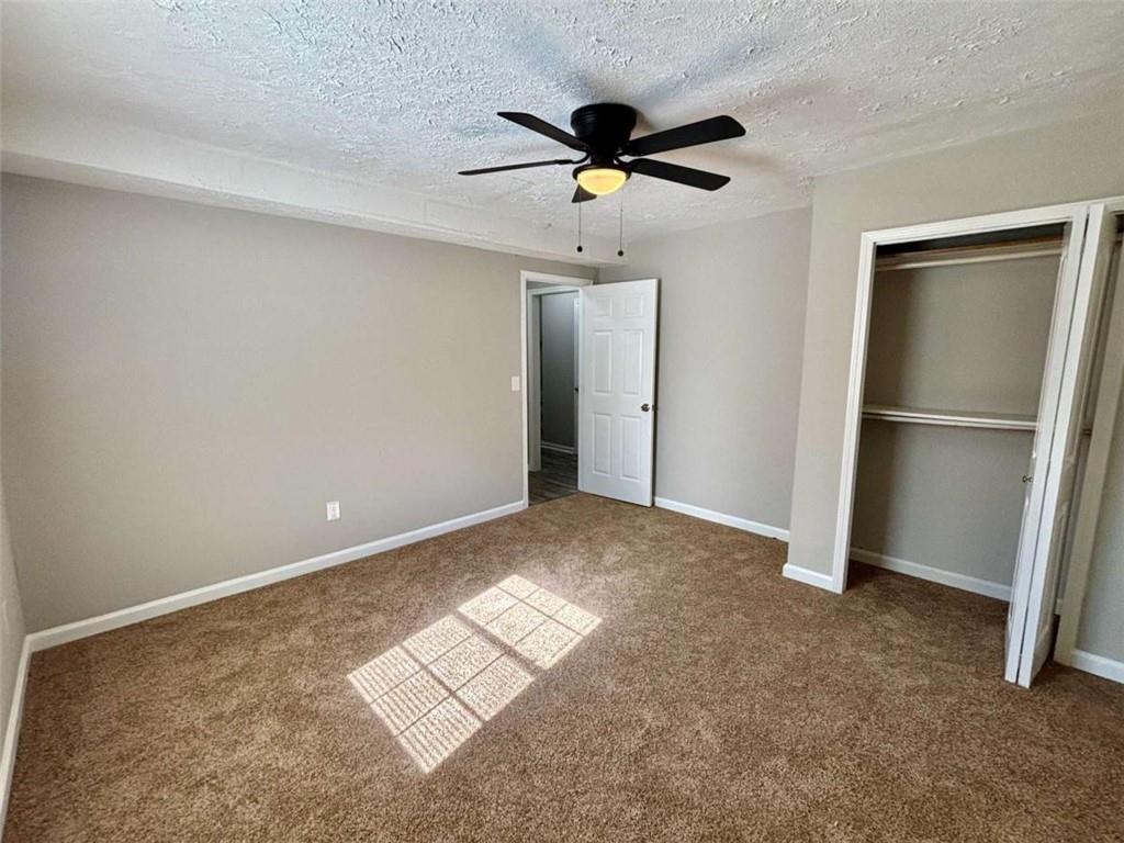 275 Thorn Brook Circle Bethlehem, GA 30620 - Photo 22 of 32 a view of empty room with wooden floor and ceiling fan