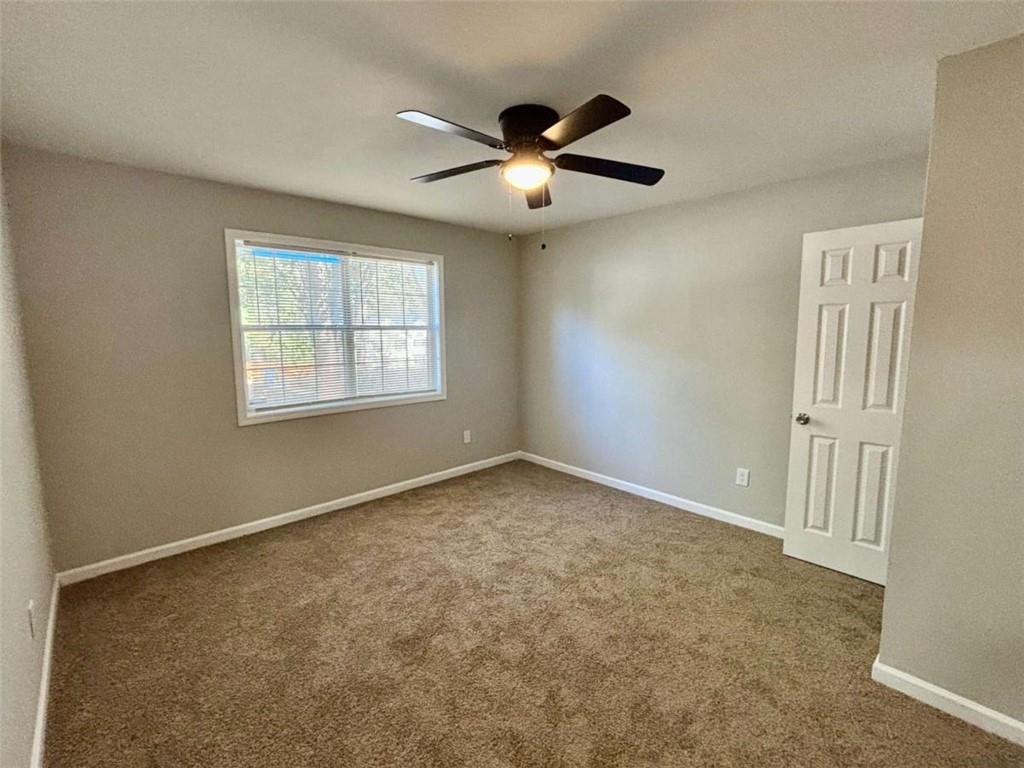 275 Thorn Brook Circle Bethlehem, GA 30620 - Photo 23 of 32 an empty room with windows and fan