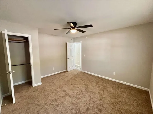 an empty room with a empty space and a ceiling fan