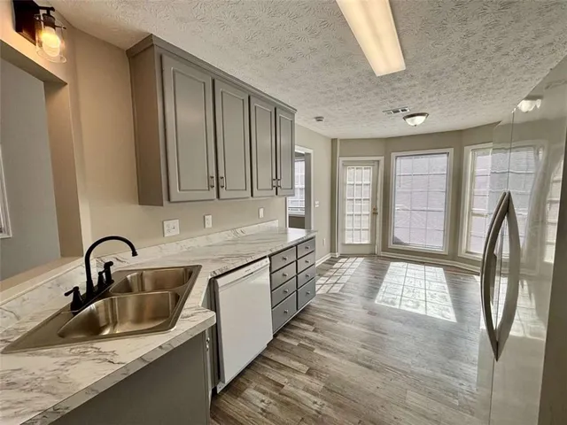 a kitchen with sink and refrigerator