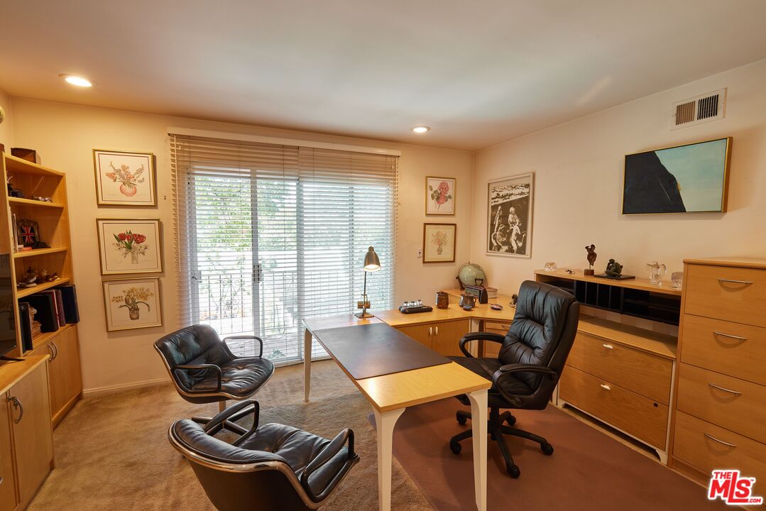 623 North Hillcrest Road Beverly Hills, CA 90210 - Photo 17 of 24 a living room with furniture a flat screen tv and a window