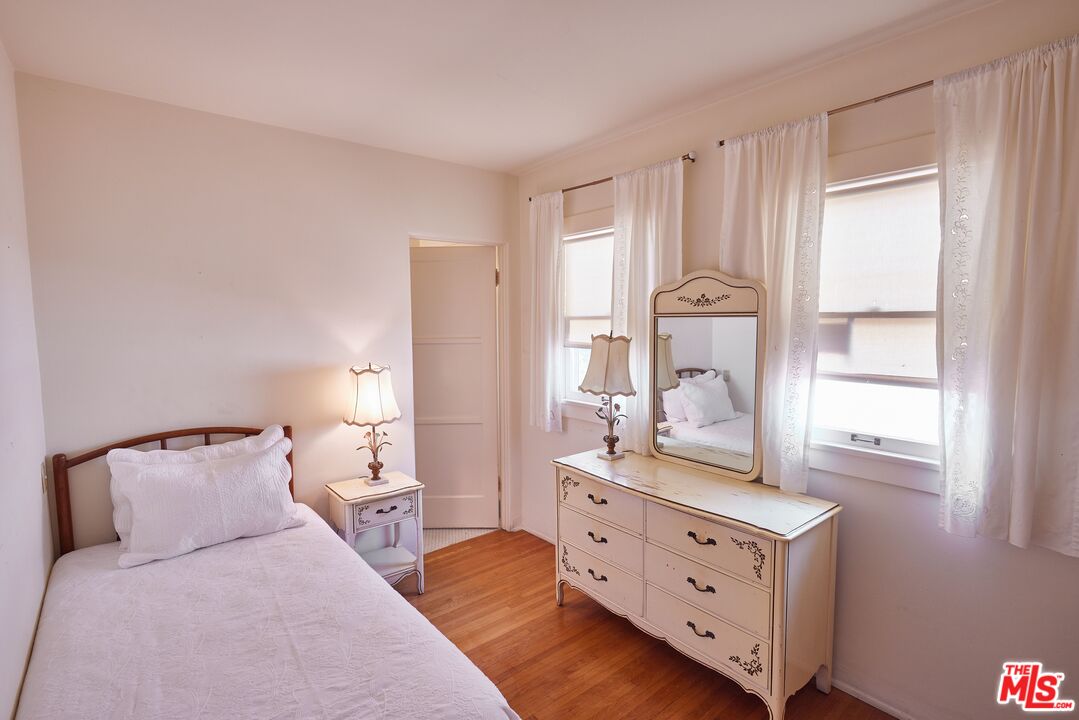 623 North Hillcrest Road Beverly Hills, CA 90210 - Photo 18 of 24 a bedroom with a bed and a dresser
