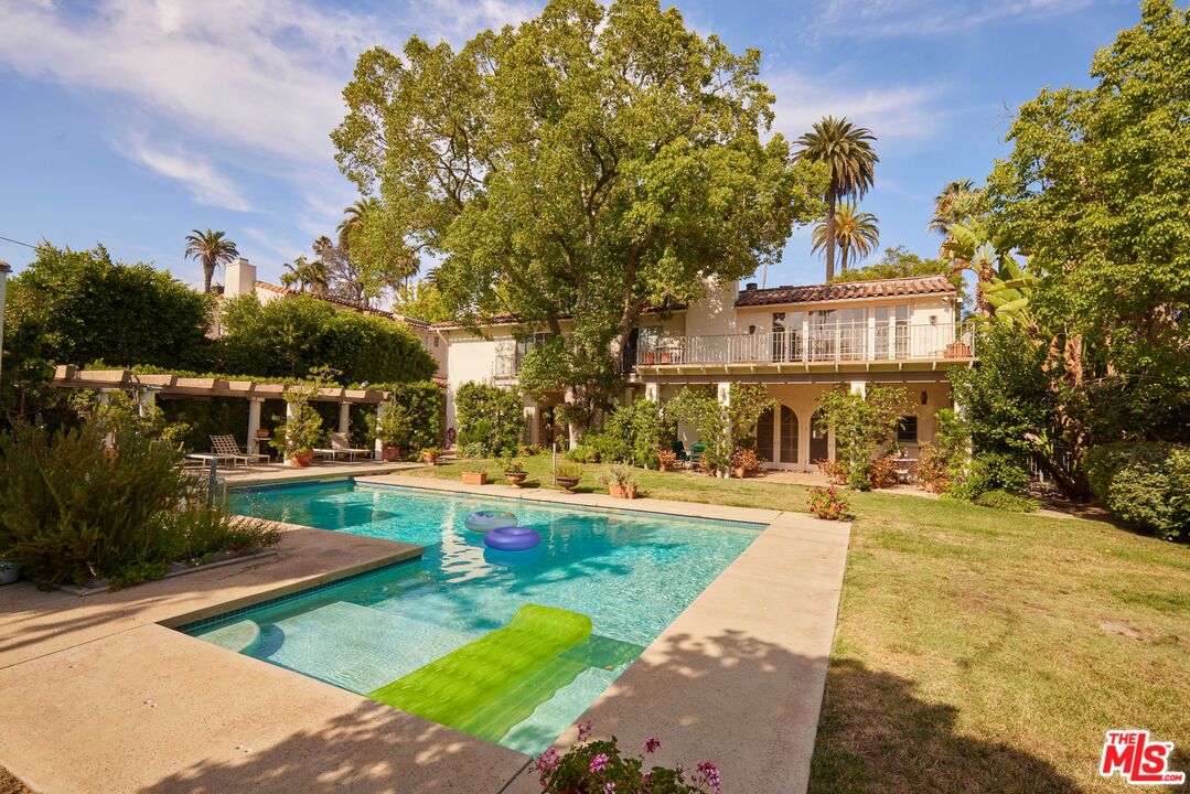 623 North Hillcrest Road Beverly Hills, CA 90210 - Photo 19 of 24 a front view of a house with garden