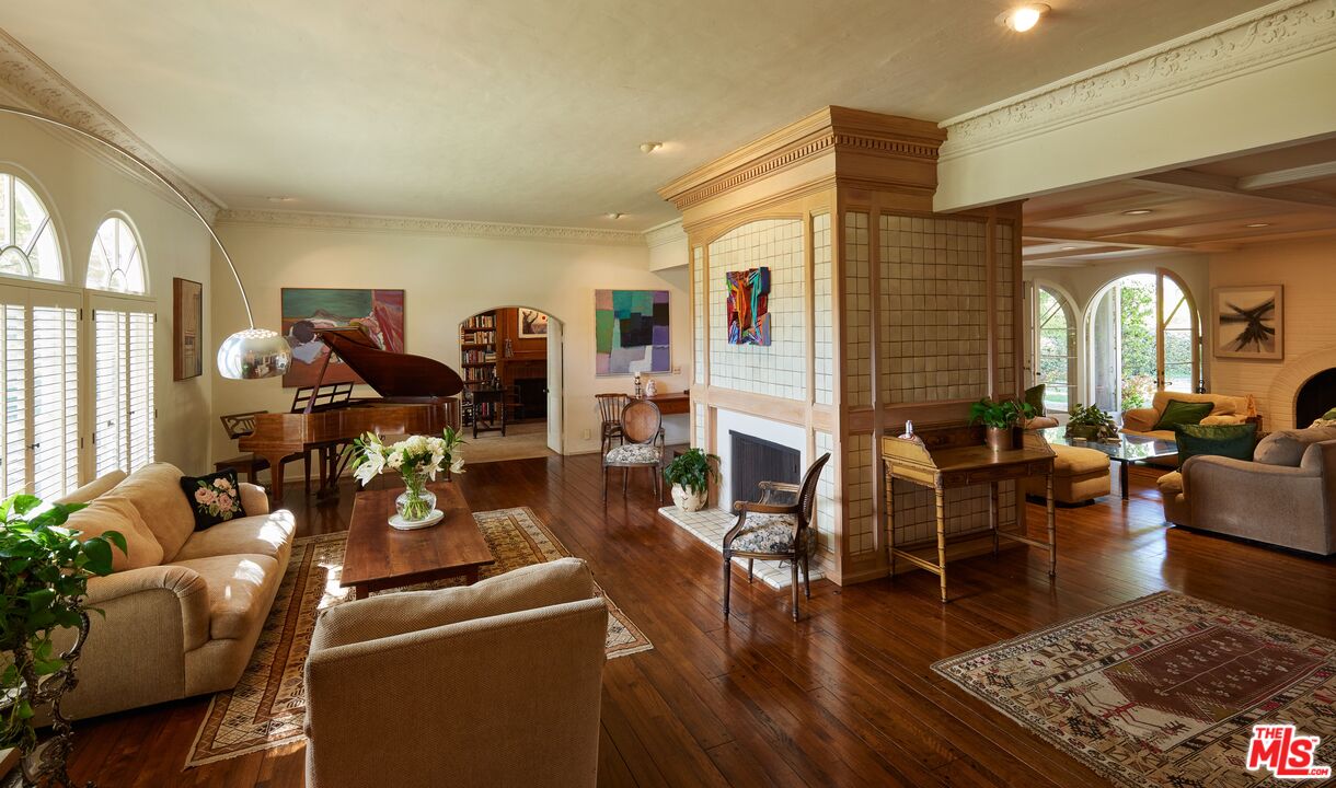 623 North Hillcrest Road Beverly Hills, CA 90210 - Photo 3 of 24 a living room with furniture dining table and a fireplace