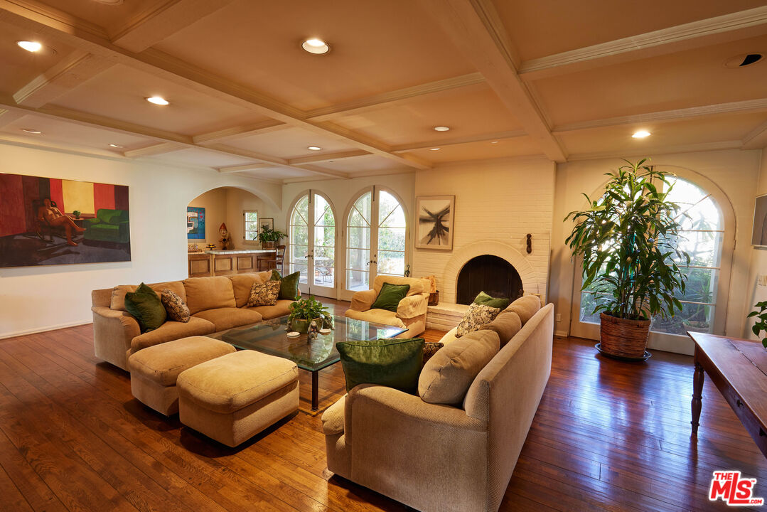 623 North Hillcrest Road Beverly Hills, CA 90210 - Photo 4 of 24 a living room with furniture fireplace and wooden floor