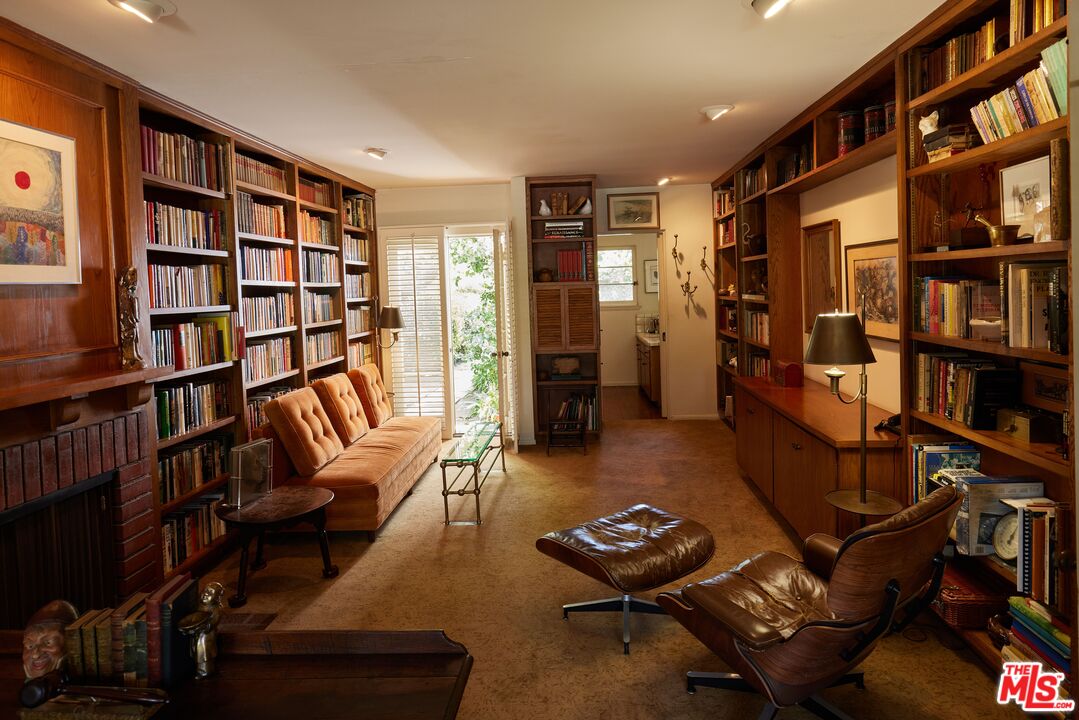 623 North Hillcrest Road Beverly Hills, CA 90210 - Photo 6 of 24 a living room with furniture a book shelf and a book shelf
