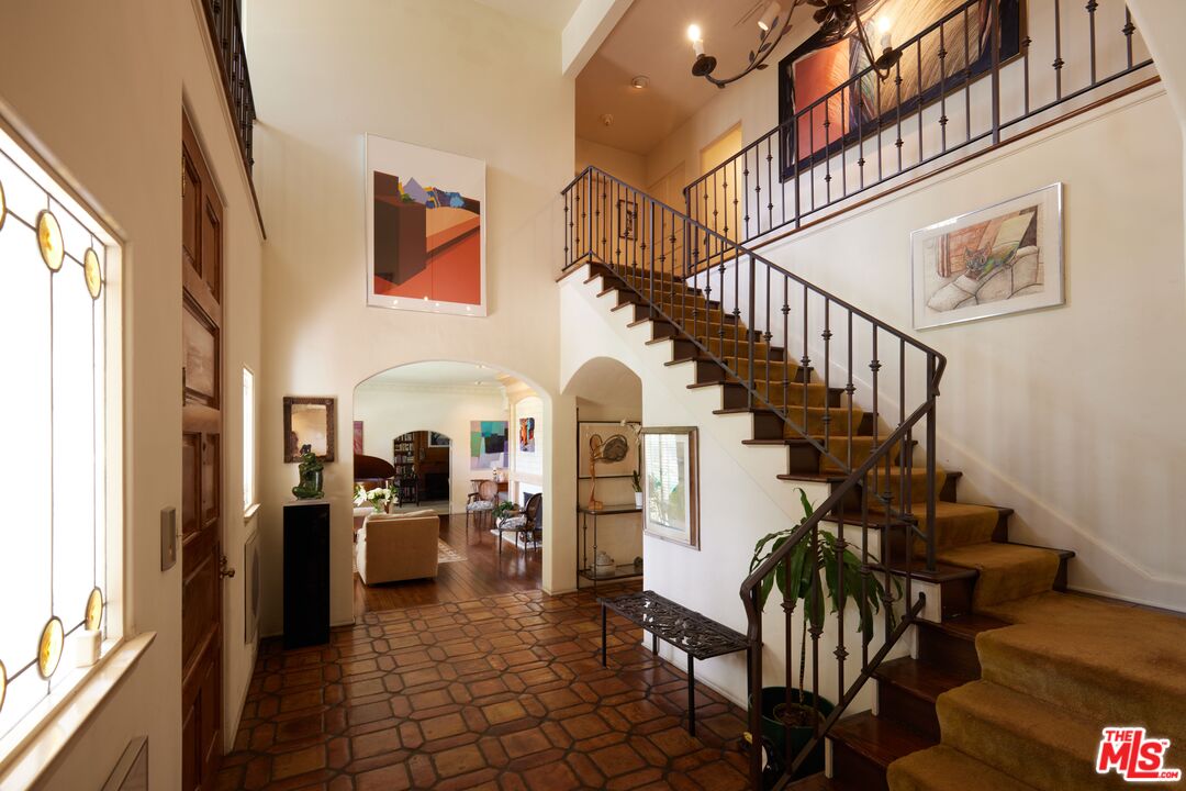 623 North Hillcrest Road Beverly Hills, CA 90210 - Photo 8 of 24 a view of a hallway with wooden floor and staircase