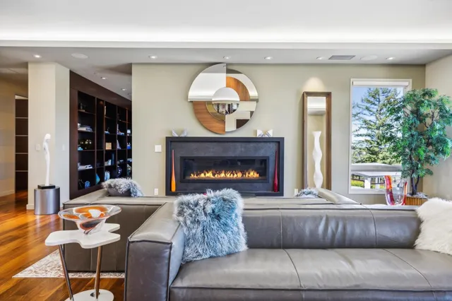a living room with furniture and a large mirror
