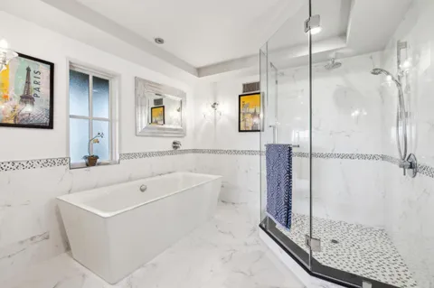 a view of a swimming pool with a yard and large trees