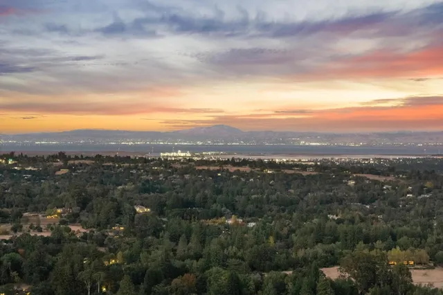 a view of a hallway with dining area and chandelier