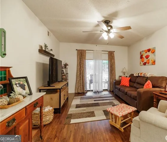 a living room with furniture and a flat screen tv