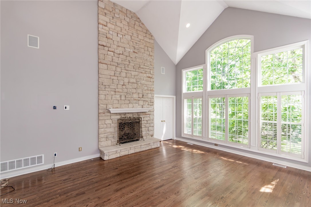 293 Burwick Road Cleveland, OH 44143 - Photo 2 of 50 Great room with vaulted ceilings, Stone gas fireplace, wall of windows with plantation shutters and hardwood floors!