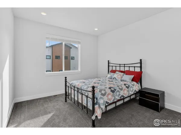 a bedroom with a bed window and a table