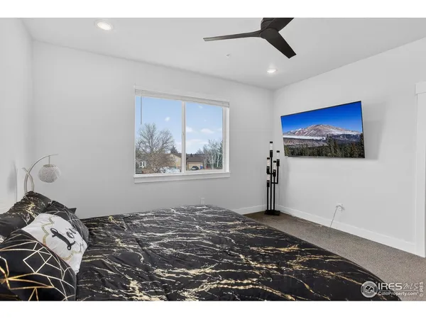 a bedroom with a bed and a painting on the wall