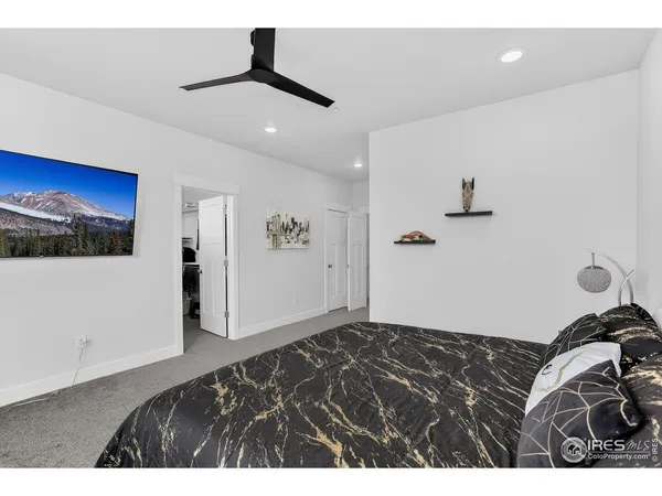 a bedroom with a bed and a view of kitchen