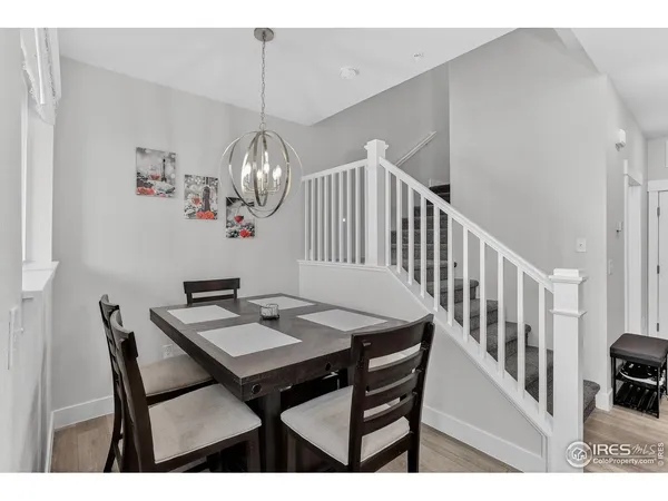 a view of a dining room with furniture wooden floor and a chandelier
