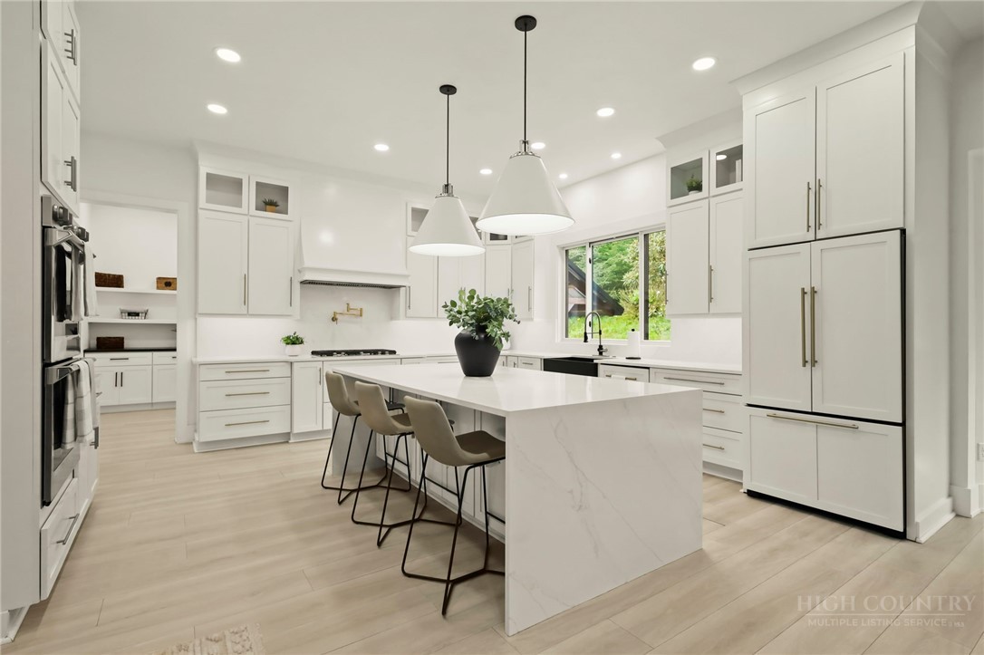 140 Wilson Ridge Road Boone, NC 28607 - Photo 16 of 48 a kitchen with white cabinets and white appliances