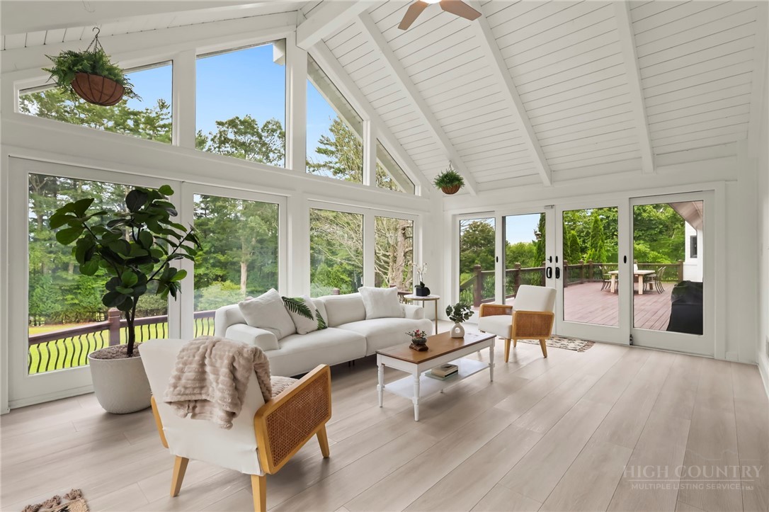 140 Wilson Ridge Road Boone, NC 28607 - Photo 20 of 48 a living room with furniture and a large window with wooden floor