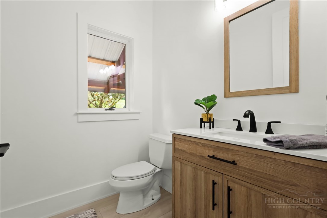 140 Wilson Ridge Road Boone, NC 28607 - Photo 23 of 48 a bathroom with a toilet sink and mirror
