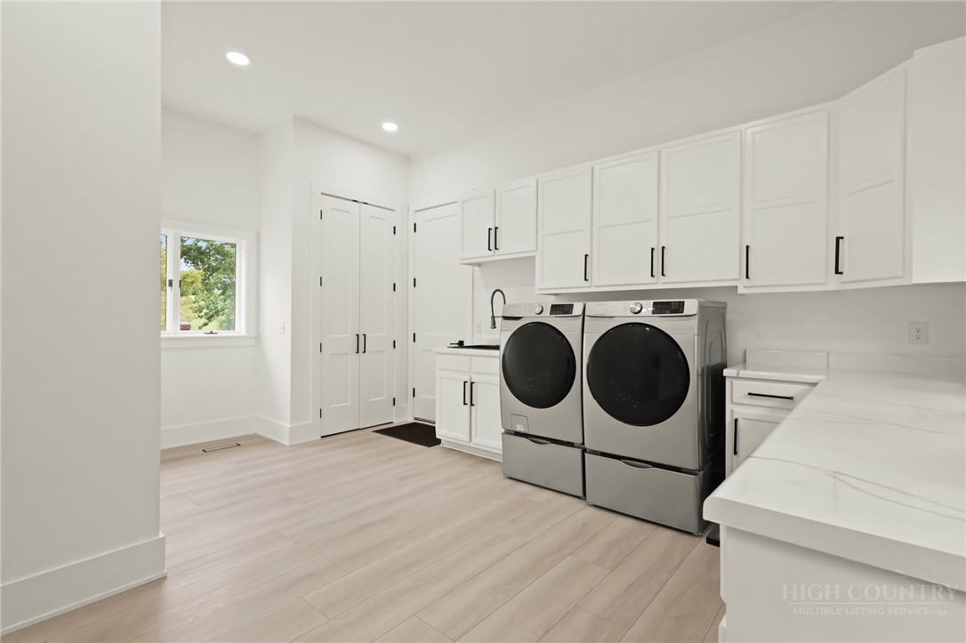 140 Wilson Ridge Road Boone, NC 28607 - Photo 24 of 48 a utility room with dryer washer and a view of kitchen