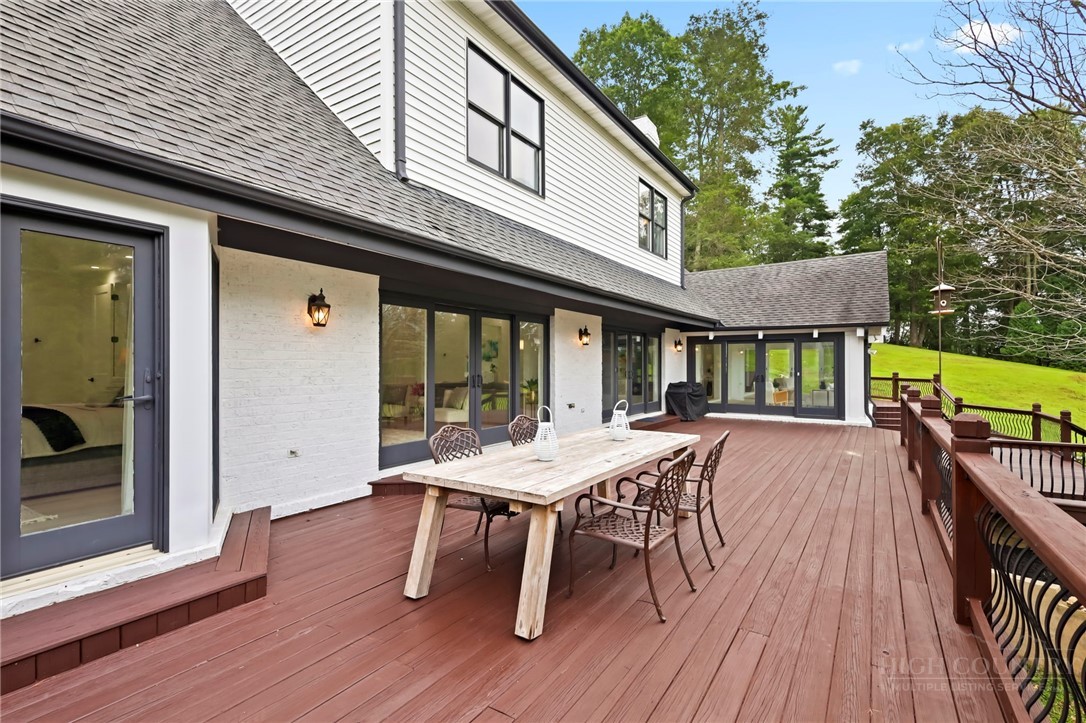 140 Wilson Ridge Road Boone, NC 28607 - Photo 32 of 48 a view of a patio with table and chairs with wooden floor and fence