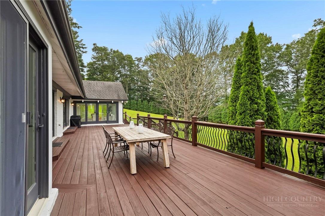 140 Wilson Ridge Road Boone, NC 28607 - Photo 33 of 48 a balcony with wooden floor and outdoor seating