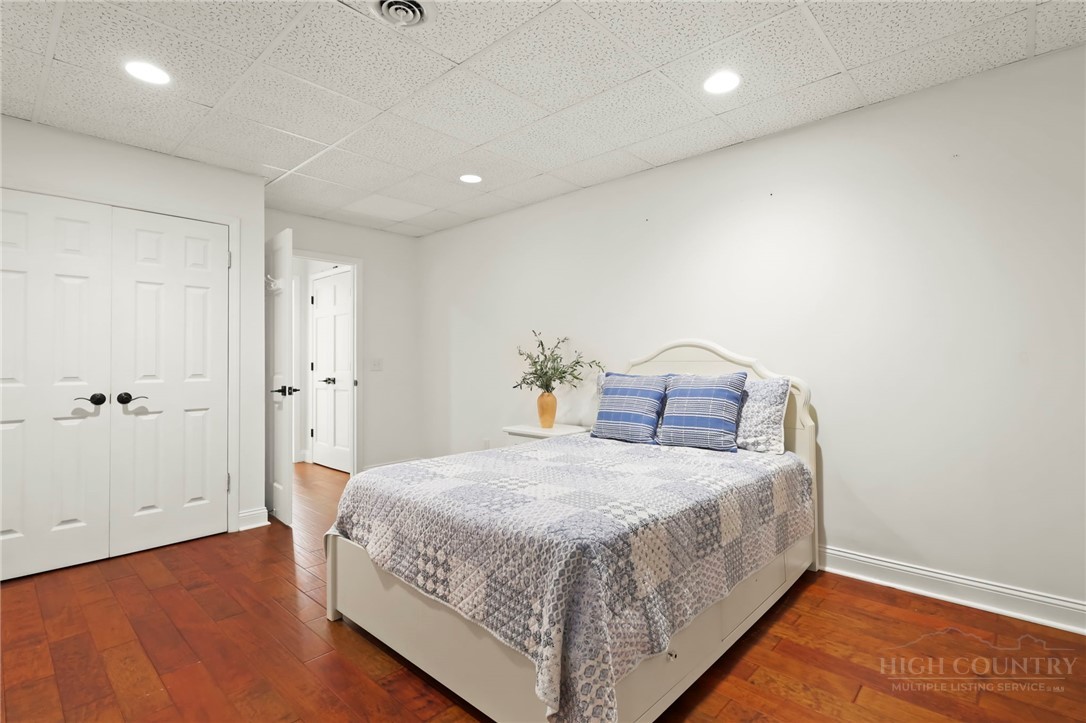 140 Wilson Ridge Road Boone, NC 28607 - Photo 42 of 48 a bedroom with a bed and wooden floor