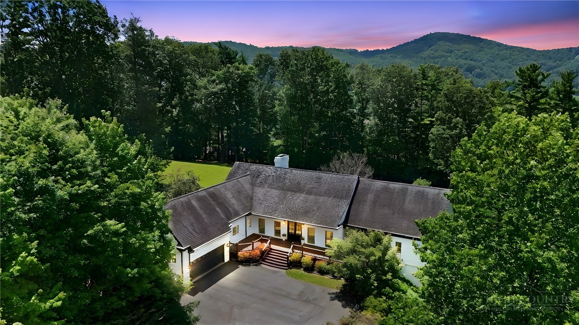 140 Wilson Ridge Road Boone, NC 28607 - Photo 5 of 48 a view of a house with a yard and a car park side of the road