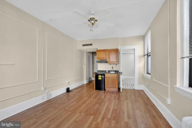 a view of kitchen with sink and wooden floor