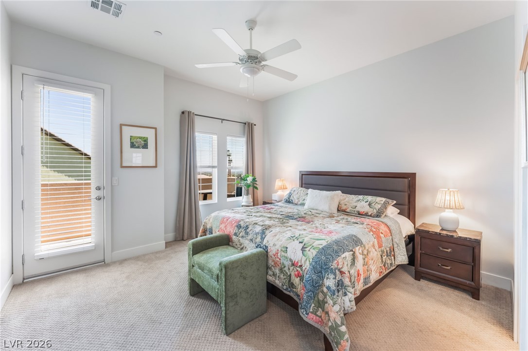 6432 Spring Jog Street Las Vegas, NV 89166 - Photo 20 of 61 Well-lit sleeping quarters include plush carpeting and a glass-paneled door leading to an outdoor area.