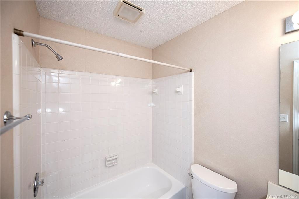 5003 Sharon Road, Unit R Charlotte, NC 28210 - Photo 15 of 23 a bathroom with a white bath tub and a shower